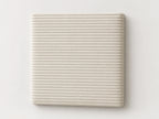 Cabecero modular · Vista del acabado pana blanca en un módulo liso de 30 × 30 × 3,5 cm